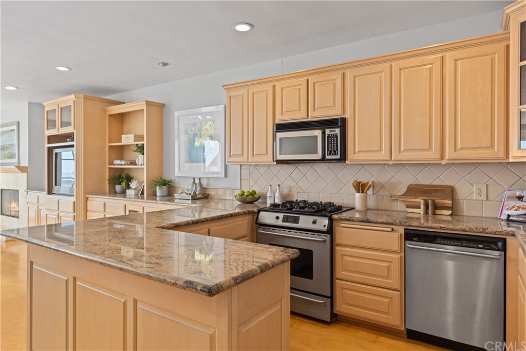 708 Cliff Drive Laguna Beach, CA 92651 - Photo 9 of 19 a kitchen with stainless steel appliances granite countertop a sink stove and cabinets