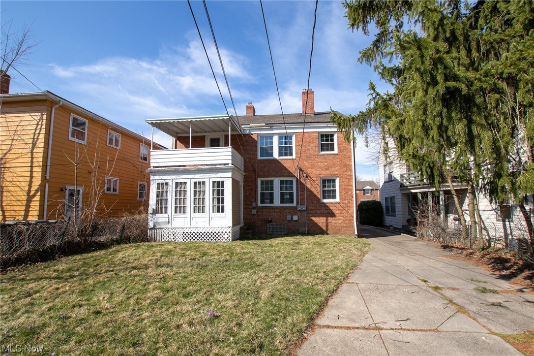 3423 Westbury Road Cleveland, OH 44120 - Photo 3 of 38 Rear view of property with a lawn, central AC, and a balcony