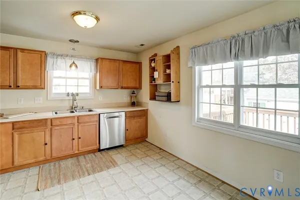 a kitchen with a sink window and cabinets