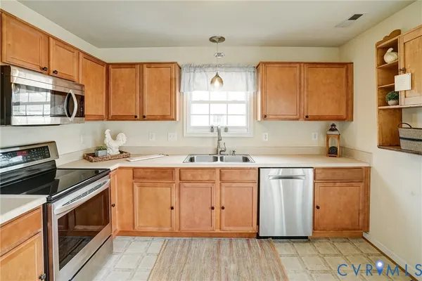 a kitchen with stainless steel appliances granite countertop a sink stove and cabinets