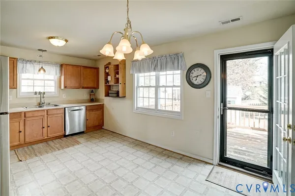 a kitchen with a stove a sink and a large window