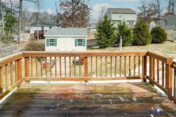 a view of a house with a wooden deck
