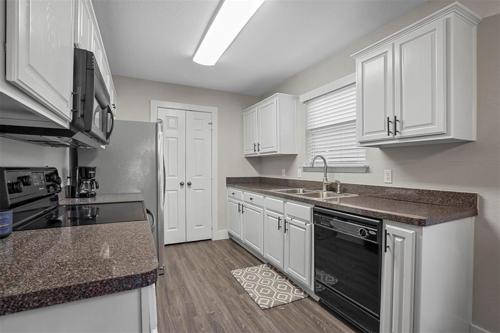 5113 Mountain Spring Trail Fort Worth, TX 76123 - Photo 11 of 35 a kitchen with granite countertop a sink stainless steel appliances and cabinets