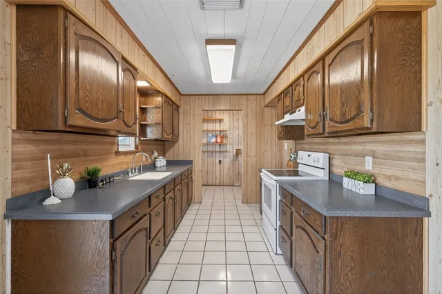 a kitchen with a sink stove and cabinets