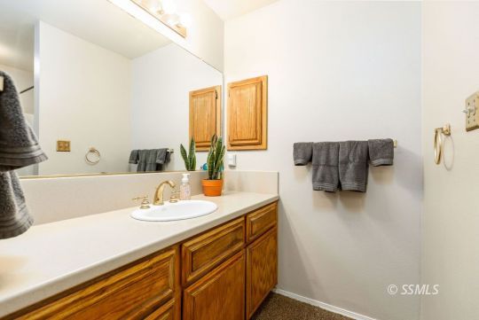 1004 Conejo Avenue Ridgecrest, CA 93555 - Photo 25 of 33 a bathroom with a sink and a mirror