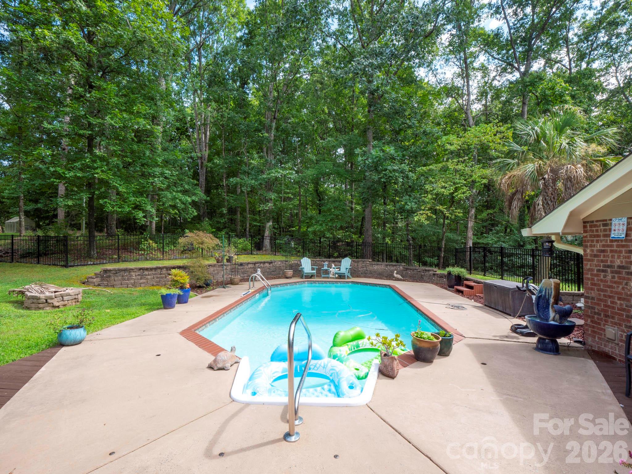 8720 Unionville-Brief Road Monroe, NC 28110 - Photo 16 of 35 a view of a swimming pool with a lounge chairs