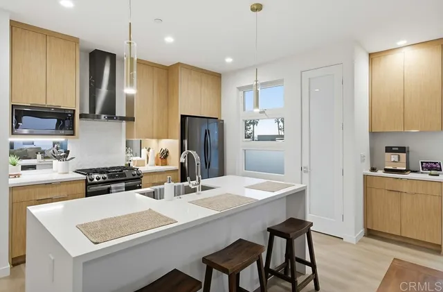 a kitchen with a refrigerator a stove a sink and a refrigerator