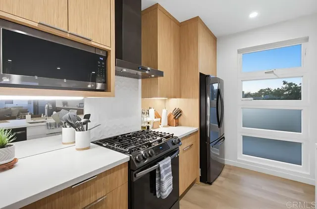 a kitchen with a stove and a refrigerator