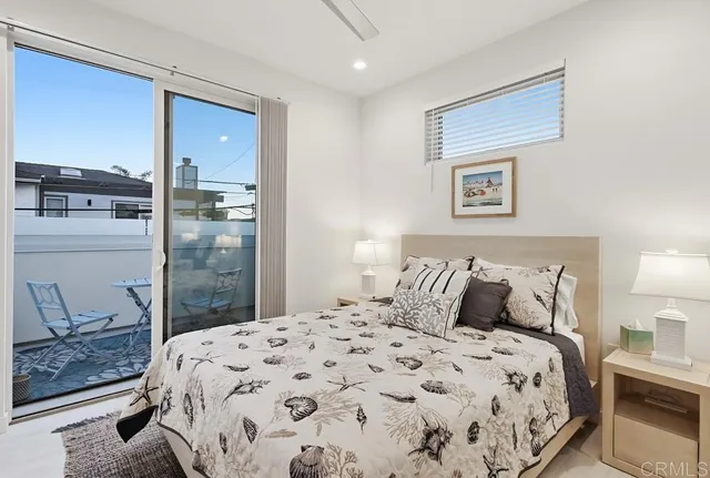 a bedroom with a bed and painting on the wall