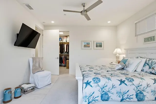 a bedroom with a bed and flat screen tv