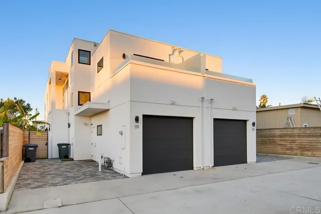 a view of a blue house with a large parking space