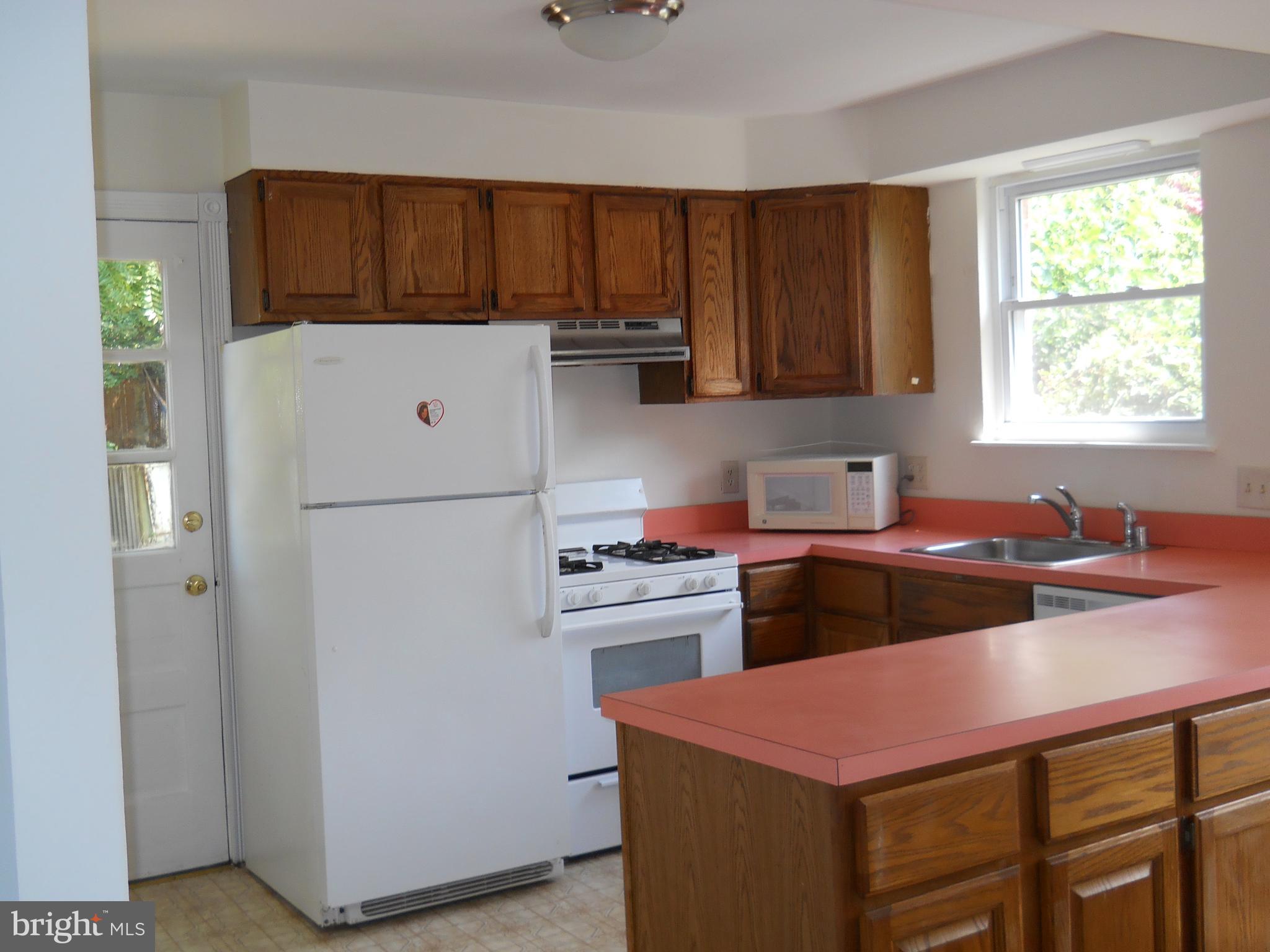 12607 Dean Road Silver Spring, MD 20906 - Photo 11 of 34 a kitchen with a stove a refrigerator and a sink