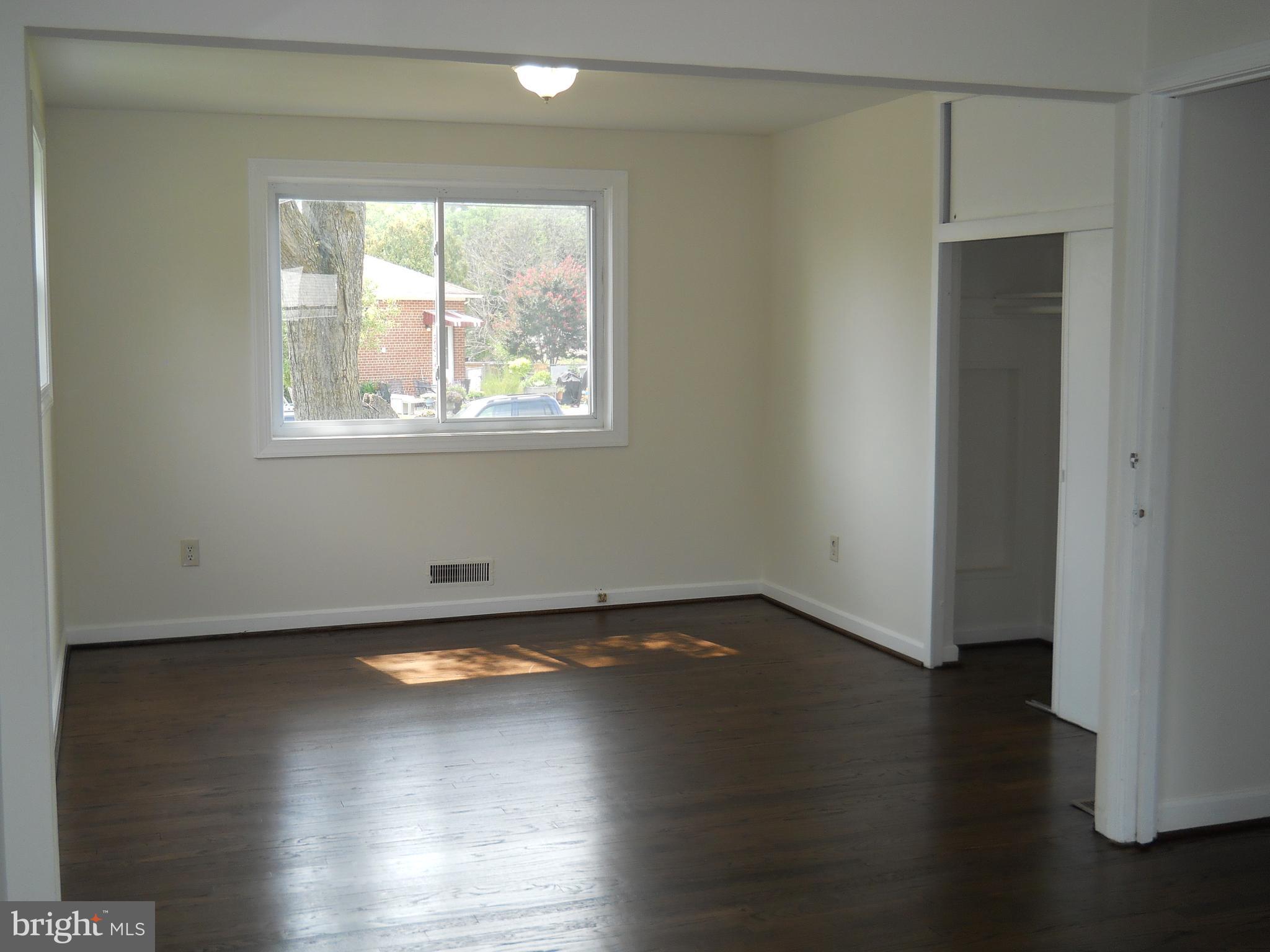 12607 Dean Road Silver Spring, MD 20906 - Photo 13 of 34 a view of an empty room with wooden floor and a window