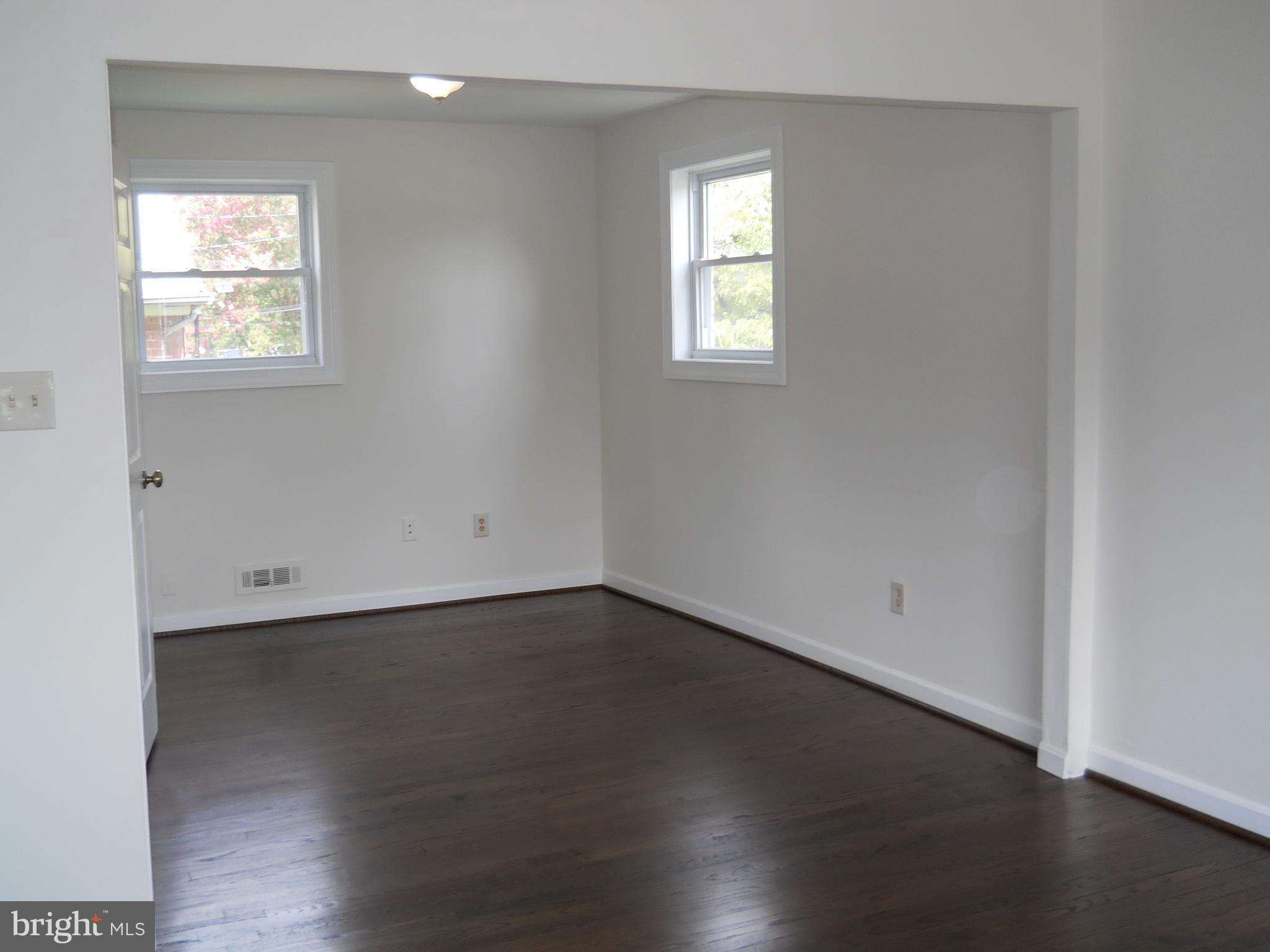 12607 Dean Road Silver Spring, MD 20906 - Photo 14 of 34 an empty room with wooden floor and windows