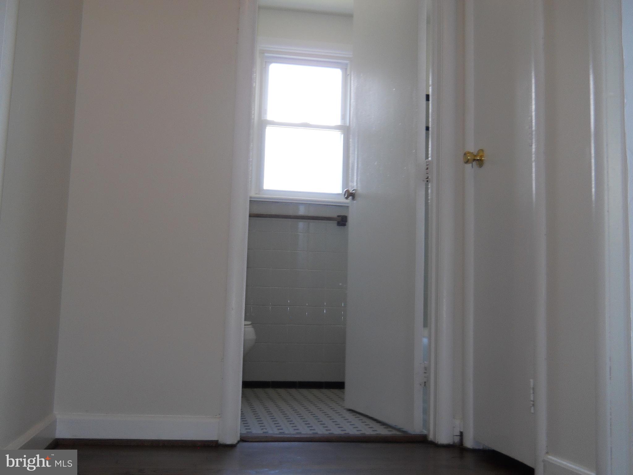 12607 Dean Road Silver Spring, MD 20906 - Photo 20 of 34 a view of a small space with wooden floor and a window