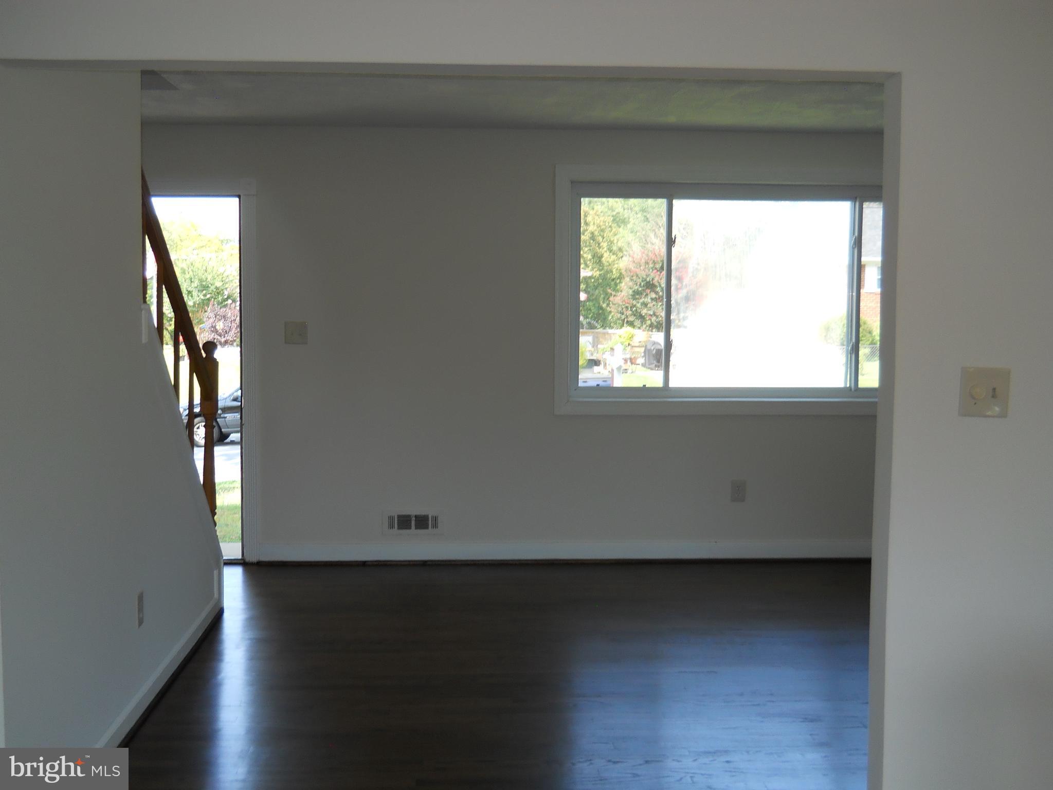 12607 Dean Road Silver Spring, MD 20906 - Photo 4 of 34 an empty room with wooden floor and windows