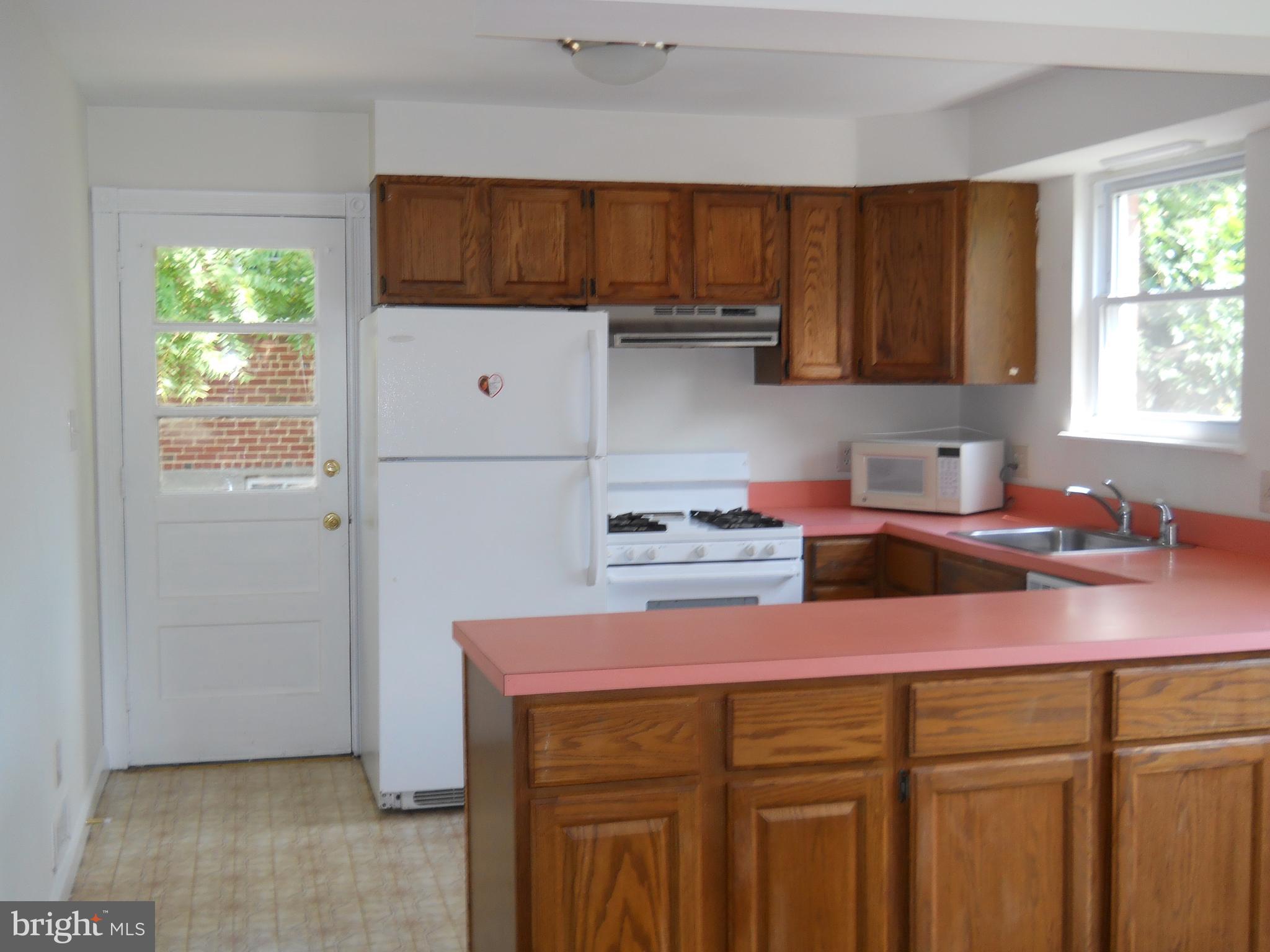 12607 Dean Road Silver Spring, MD 20906 - Photo 10 of 34 a kitchen with a sink cabinets and window