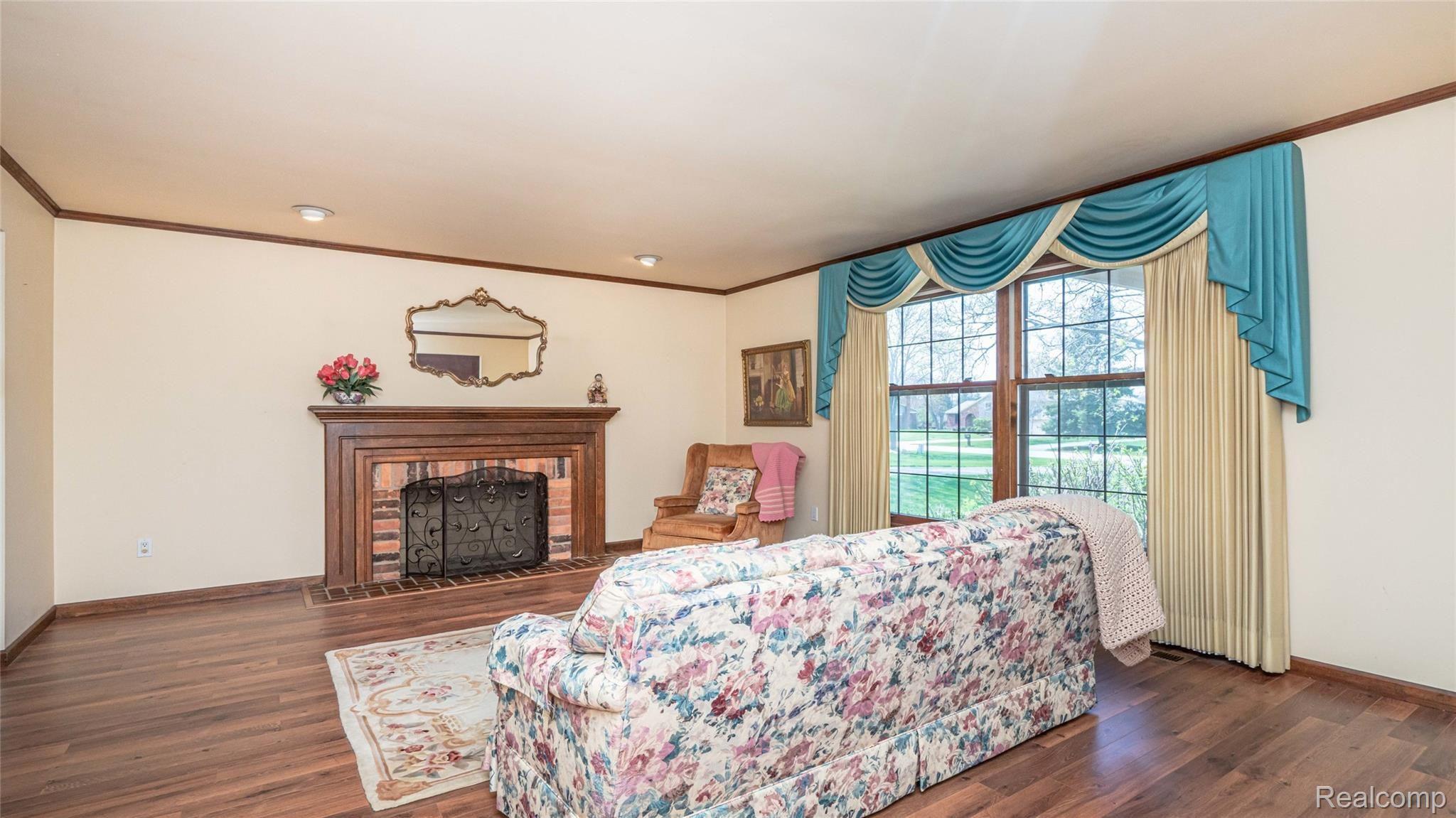 5330 Inverrary Lane Commerce Township, MI 48382 - Photo 20 of 76 Laminate flooring and natural fireplace.