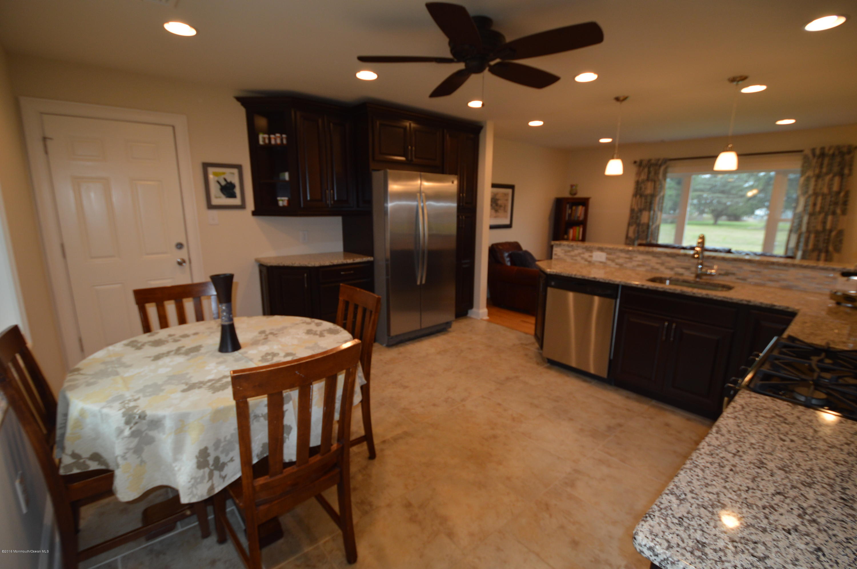 260 Adelphia Road Farmingdale, NJ 07727 - Photo 11 of 30 a large kitchen with stainless steel appliances a large counter top a stove and a sink