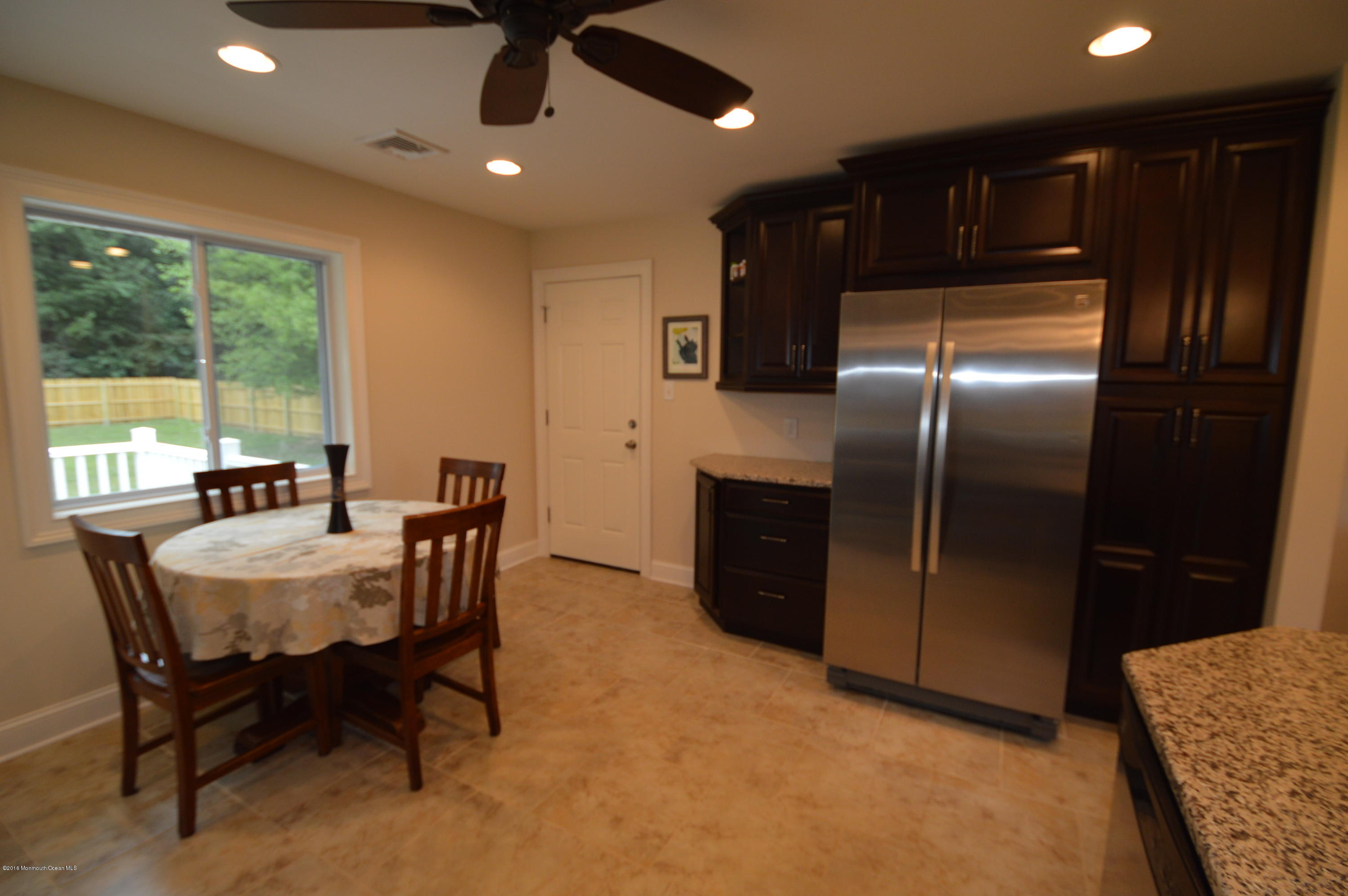 260 Adelphia Road Farmingdale, NJ 07727 - Photo 13 of 30 a kitchen with refrigerator a sink and chairs