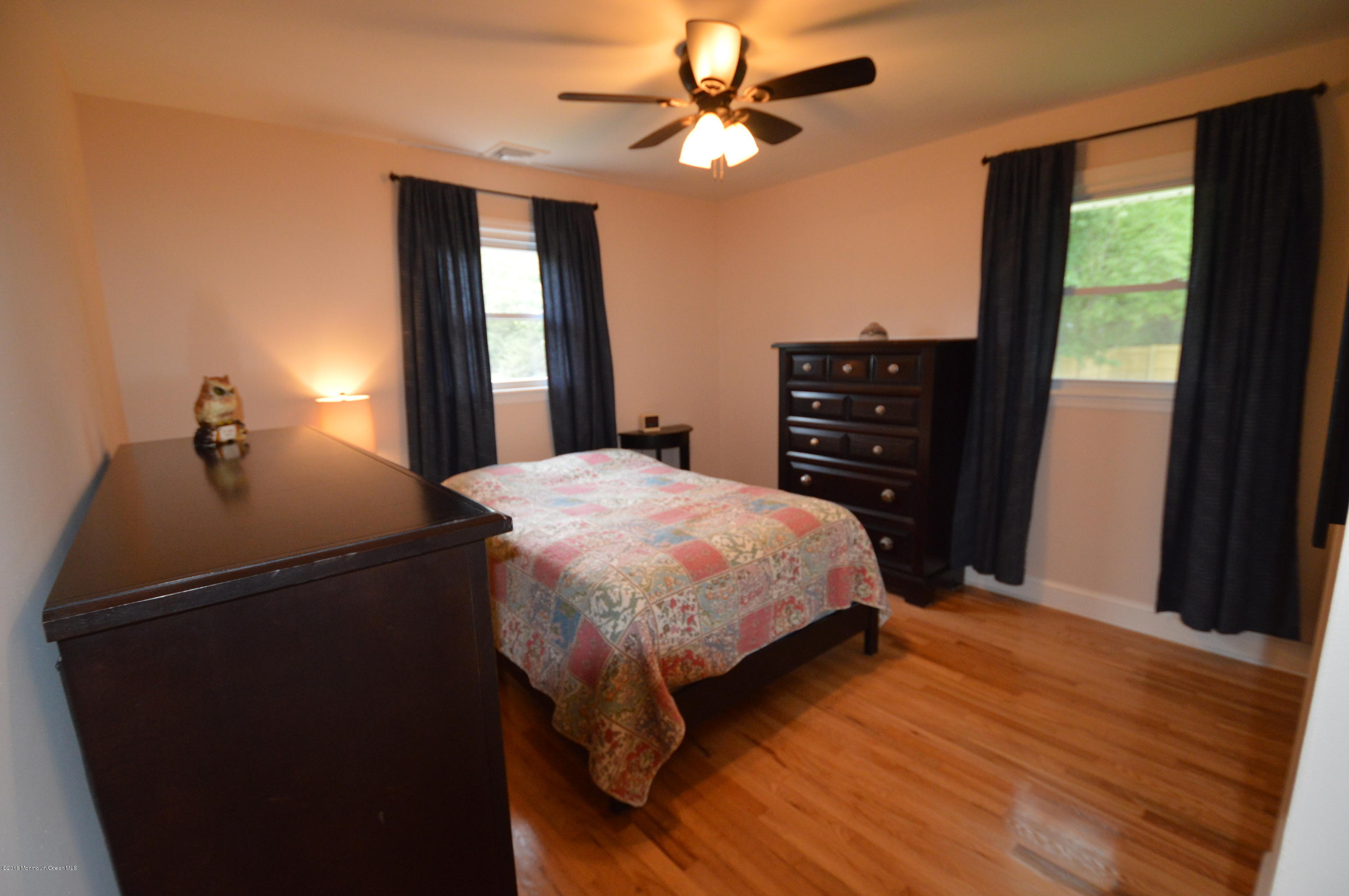 260 Adelphia Road Farmingdale, NJ 07727 - Photo 14 of 30 a bed sitting in a bedroom next to a window