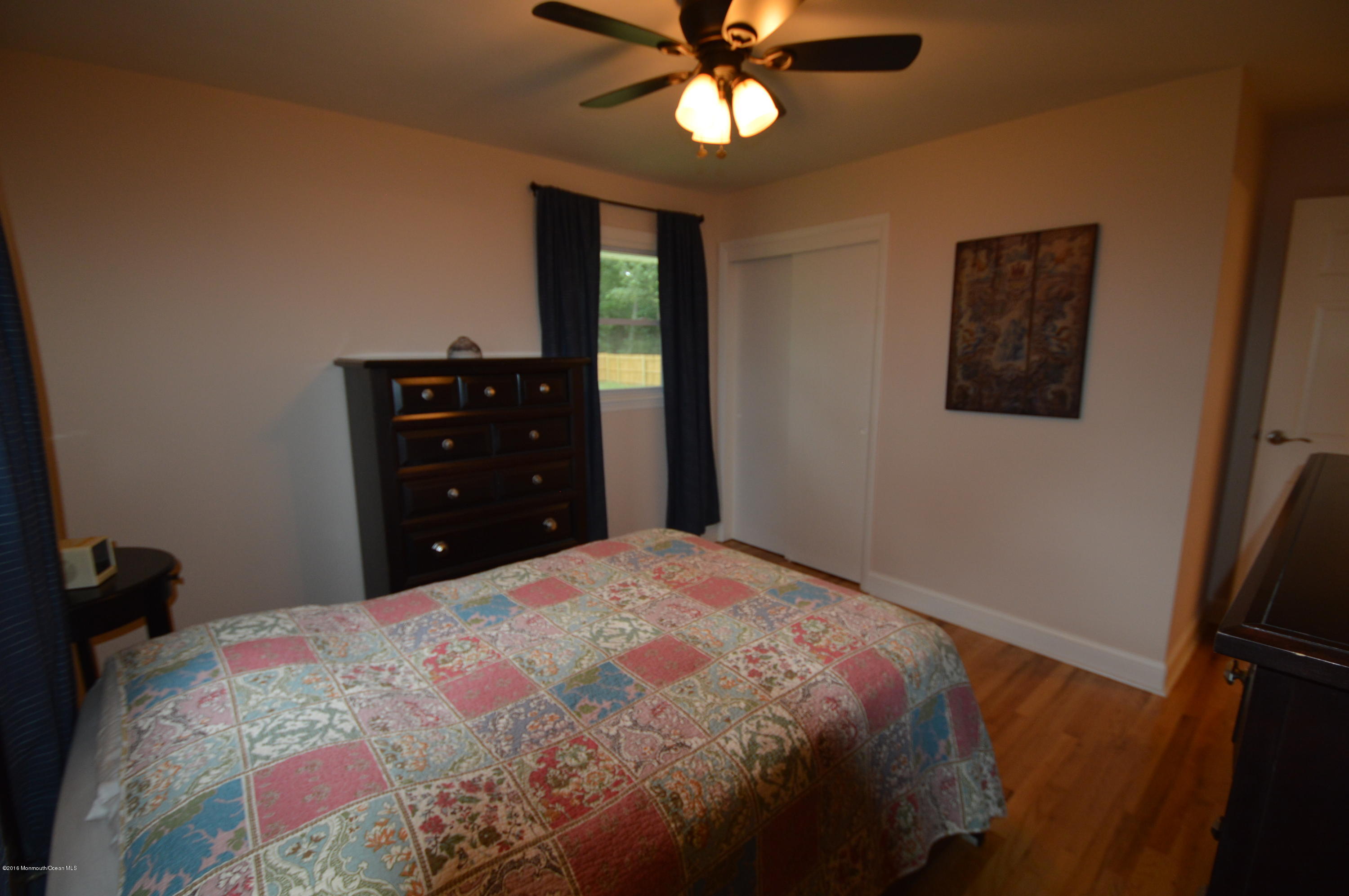 260 Adelphia Road Farmingdale, NJ 07727 - Photo 15 of 30 a bedroom with a bed and a window