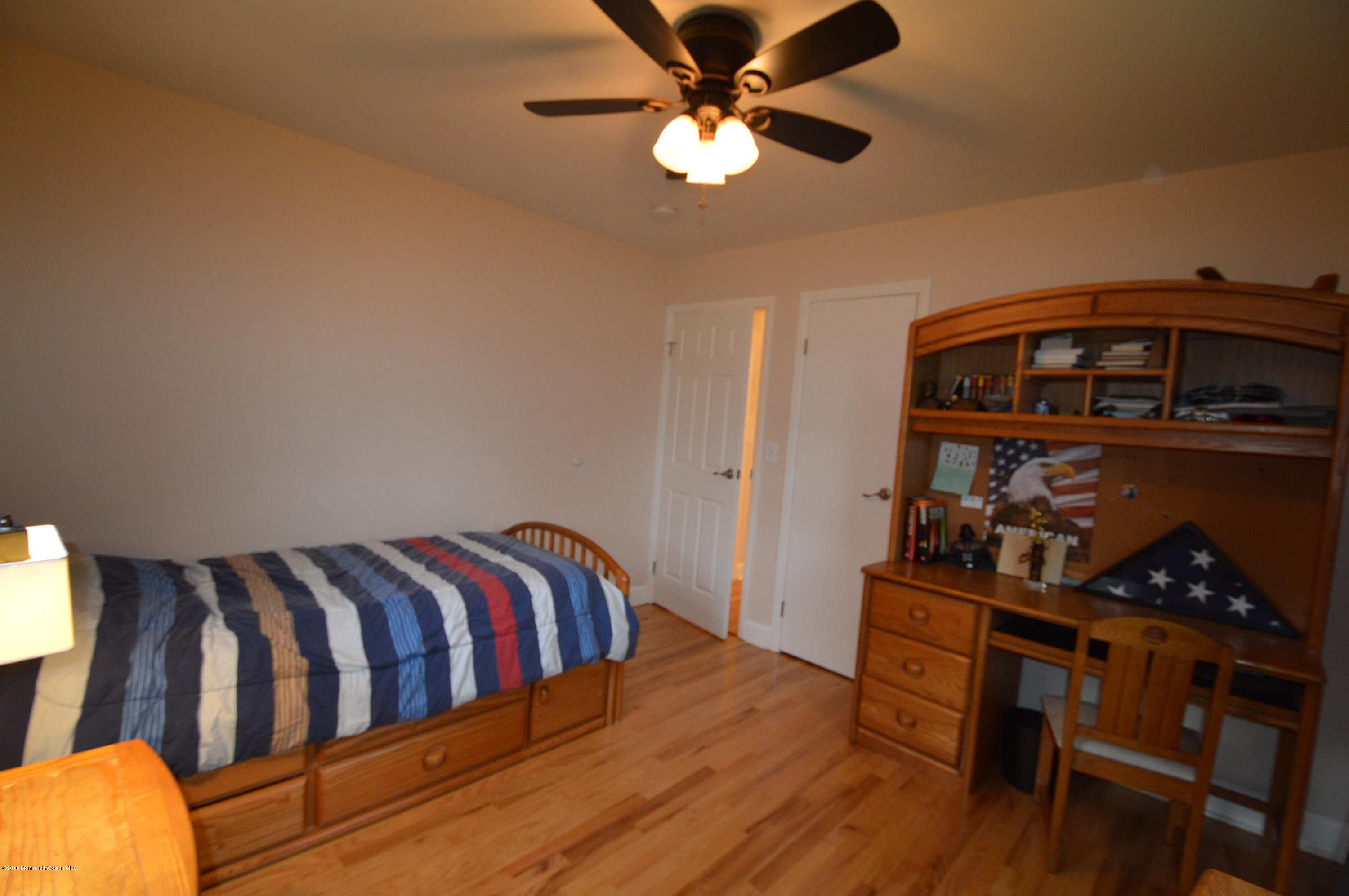 260 Adelphia Road Farmingdale, NJ 07727 - Photo 17 of 30 a bedroom with furniture and a wooden floor