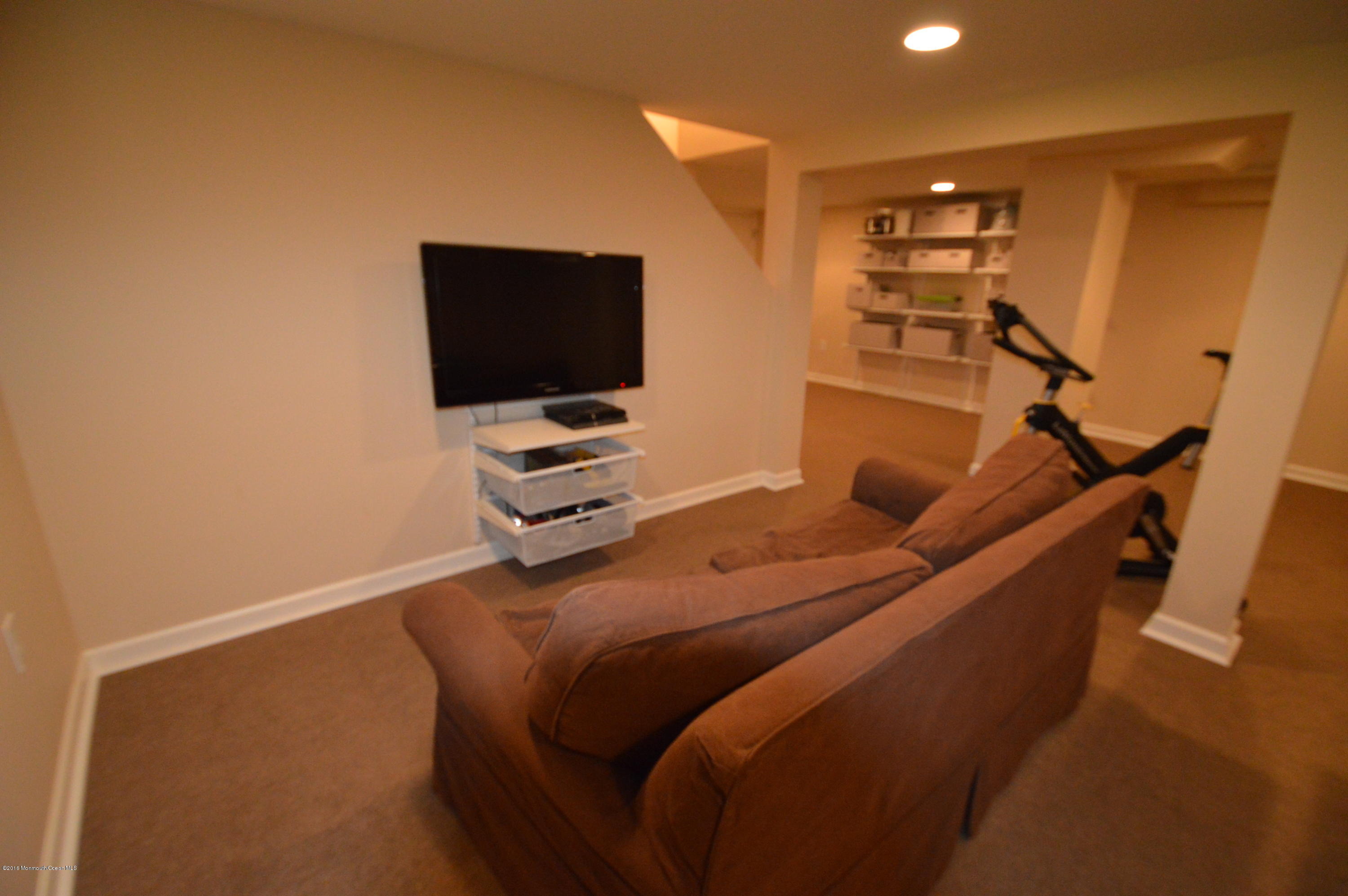 260 Adelphia Road Farmingdale, NJ 07727 - Photo 23 of 30 a bedroom with a bed and a flat screen tv