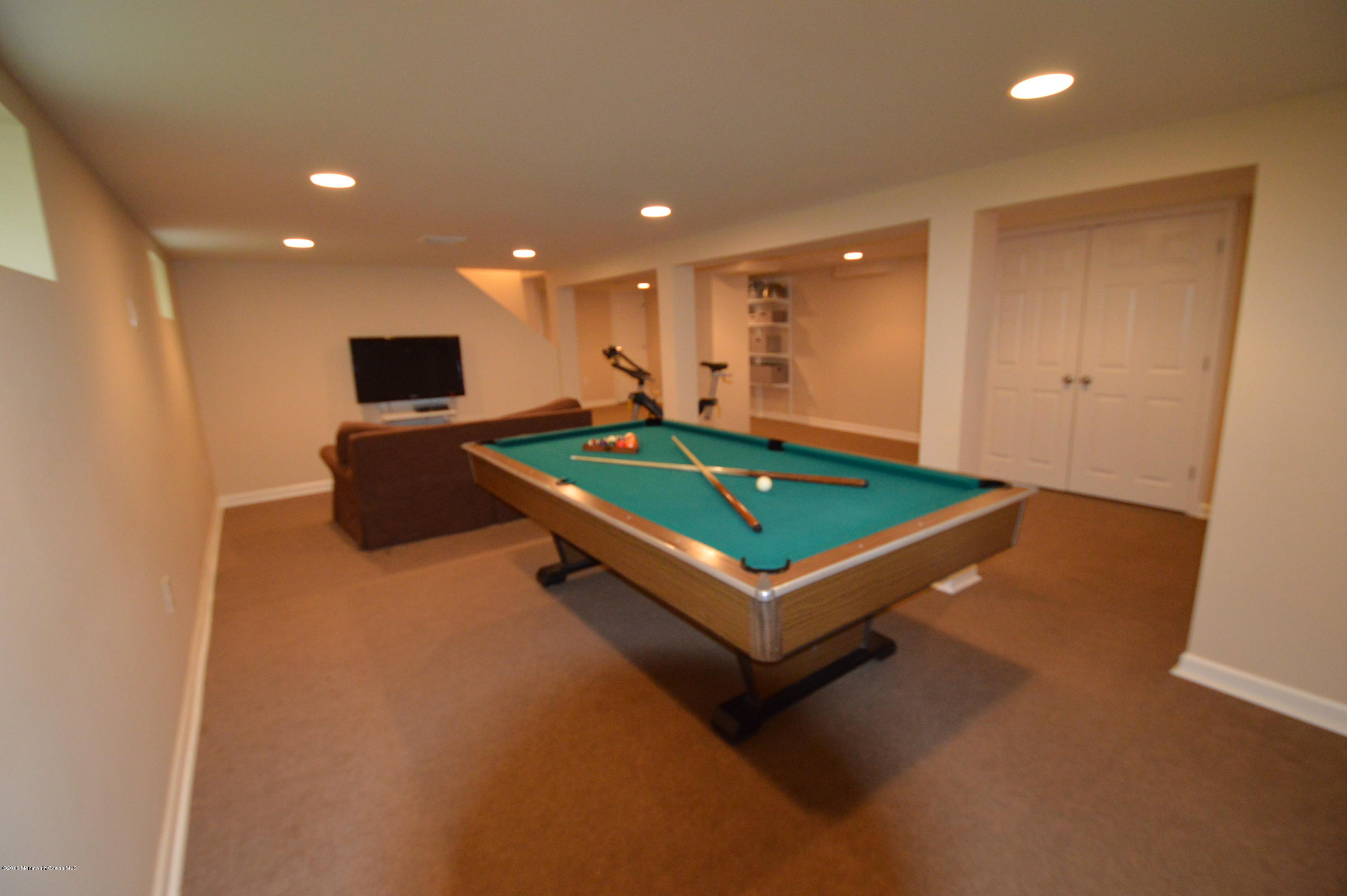 260 Adelphia Road Farmingdale, NJ 07727 - Photo 25 of 30 a room with pool table and a flat screen tv