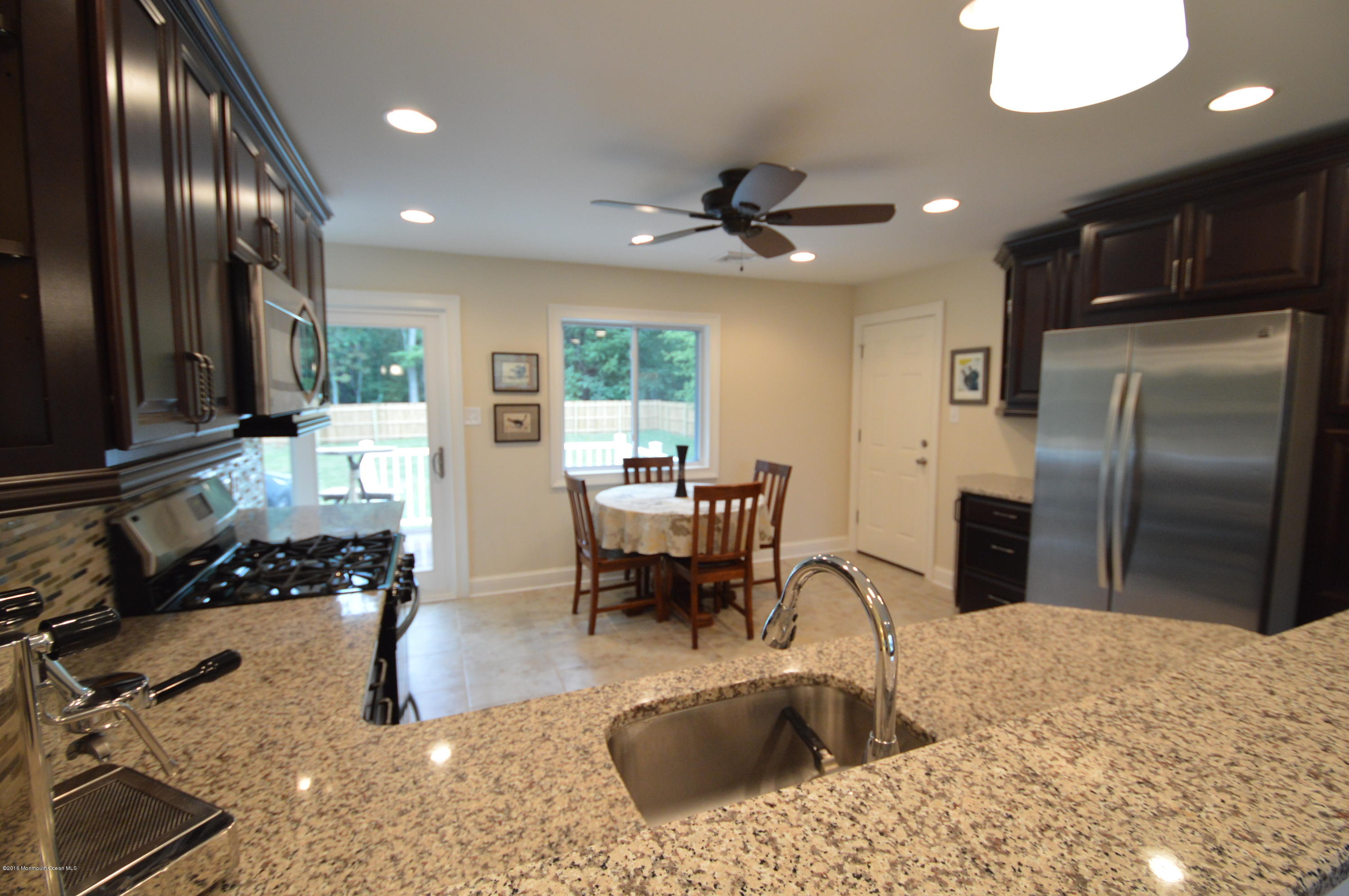 260 Adelphia Road Farmingdale, NJ 07727 - Photo 8 of 30 a kitchen with granite countertop a refrigerator and a sink