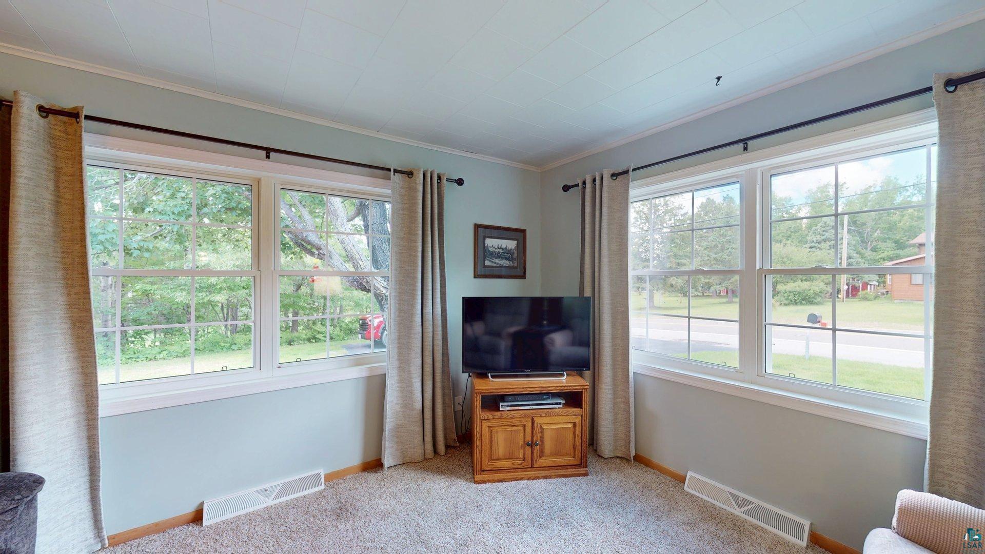 10614 Moose Lake Road Orr, MN 55771 - Photo 17 of 44 Bright interior space featuring multiple double-hung windows with white trim