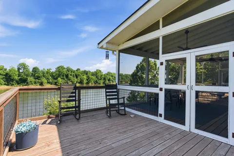 a view of a deck with chairs and wooden floor