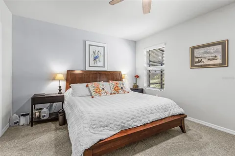 a bedroom with a bed and wall painting