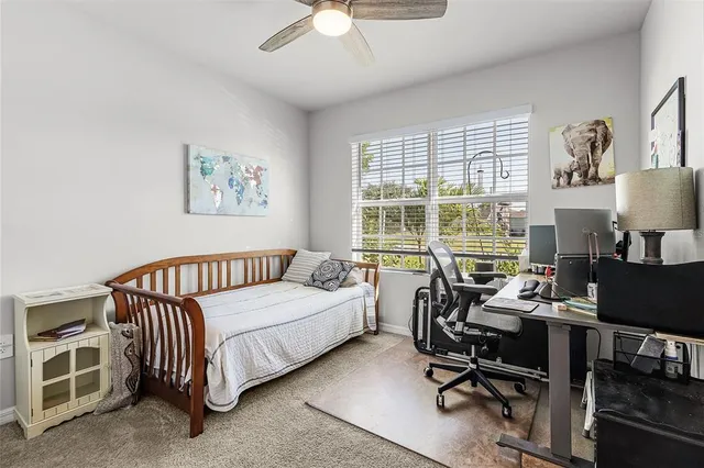 a bedroom with a bed and a desk