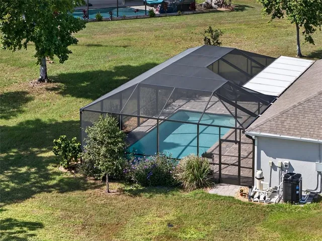 a view of a backyard with plants and lake view