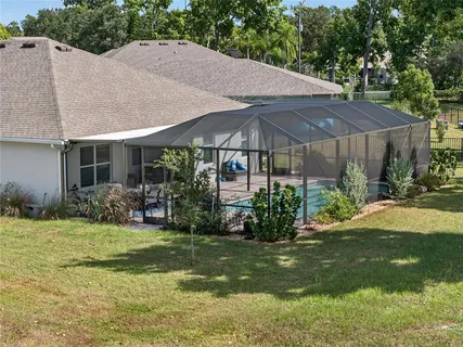 a view of a house with yard and sitting area