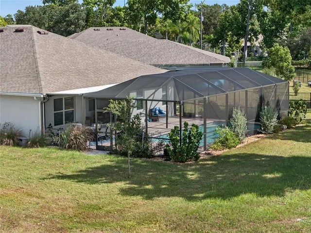 a view of a house with yard and sitting area