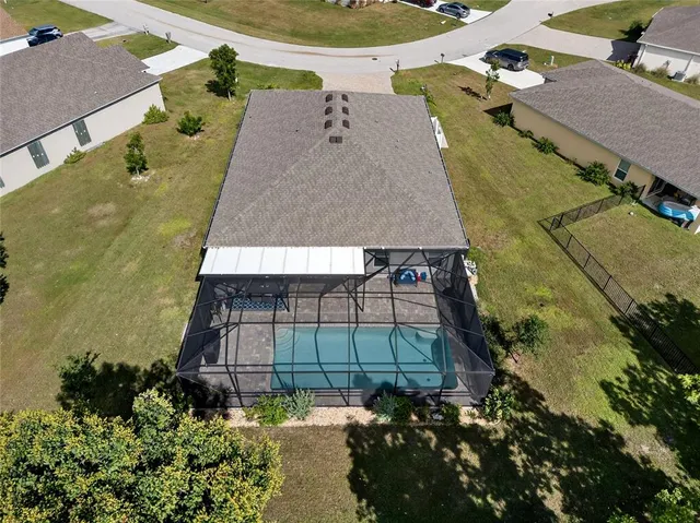 an aerial view of a house with a yard