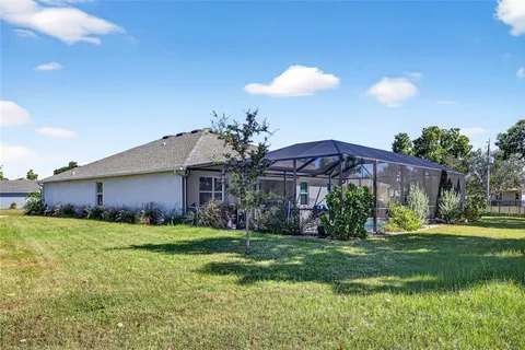 a view of a house with a yard and plants