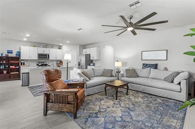 a living room with furniture and kitchen view