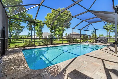 a view of a patio with a table and chairs under an umbrella