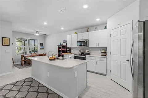 a kitchen with refrigerator and cabinets