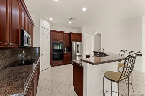 a spacious bedroom with a bed and a flat screen tv