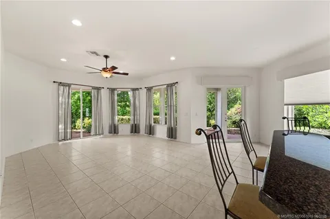 a bathroom with a granite countertop bathtub a sink and mirror