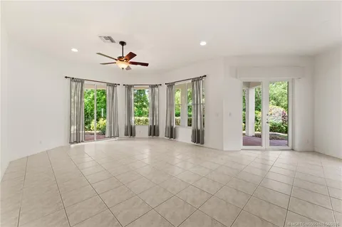 a bathroom with a granite countertop sink a toilet a mirror a vanity and shower