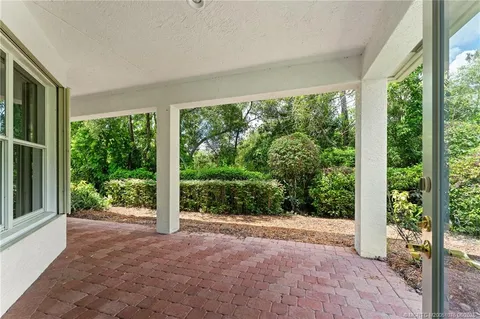 a aerial view of a house with a yard and potted plants