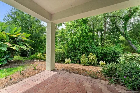 an aerial view of residential houses with outdoor space and ocean view