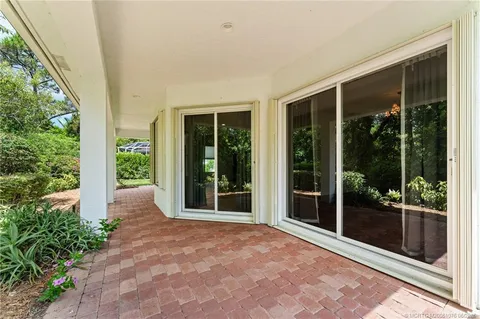 an aerial view of a house with a yard and a bench