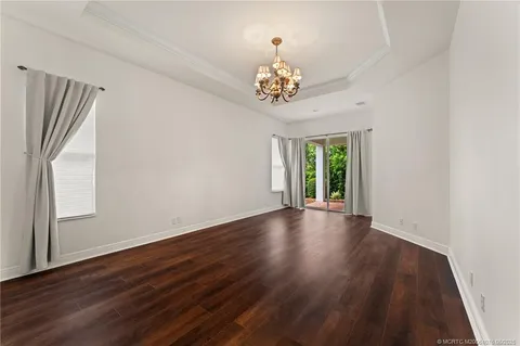 a view of a swimming pool with a yard and plants
