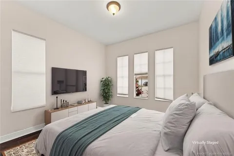 a view of a white house with a swimming pool and a yard